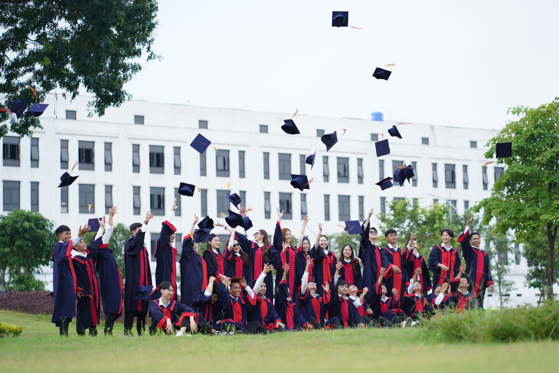 Graduates tossing caps at college commencement